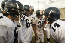 Image of a football huddle.